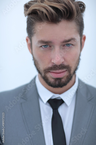 Serious businessman wearing suit and tie. blue background
