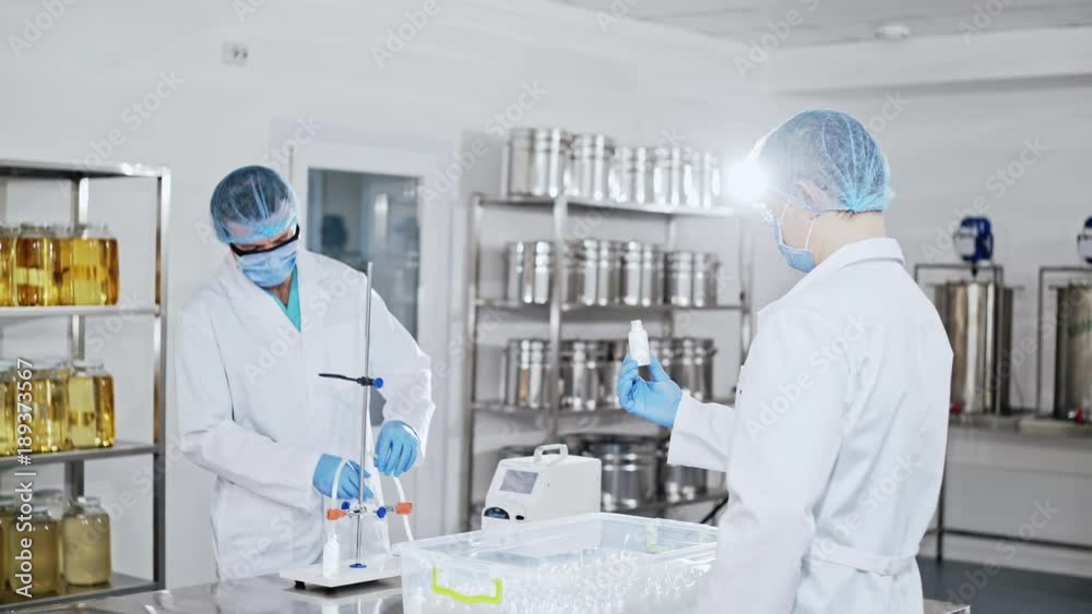 Preparation of the labolatory to the experiment. Two physicians are preparing equipment for the experiment. Preparation of the labolatory to the experiment. Two physicians are preparing equipment for the experiment.