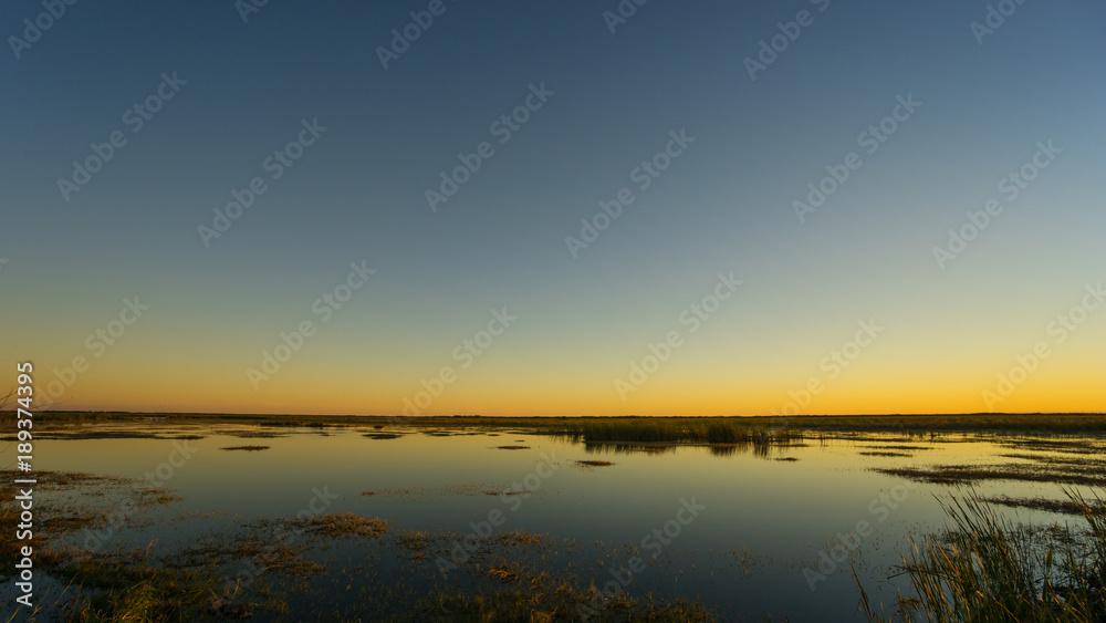 USA, Florida, Orange sky over water after sunset in everglades nature landscape