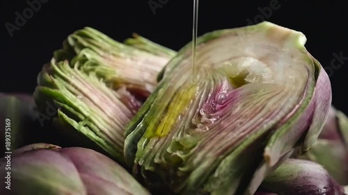 olive oil pouring on sliced artichoke