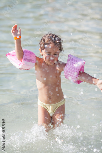 Little girl is playing in the sea