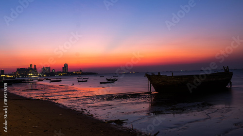 PATTAYA, THAILAND - January 14 - 2018: Fishing boats at coastal in sunset. The back of Pattaya city.