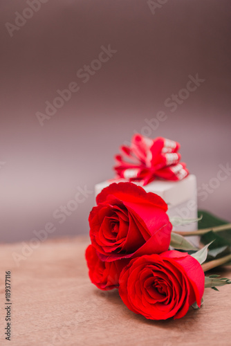 Valentines Day Background with Gift Box and Red Rose on Wood Table Rustic style