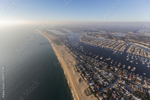 Aerial view of Newport Beach bay and harbor with afternoon pacific ocean fog rolling in.  