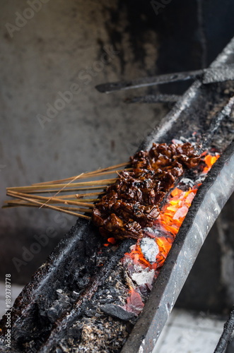 Typical Indonesian dish Sate ayam on local street market - vertical.