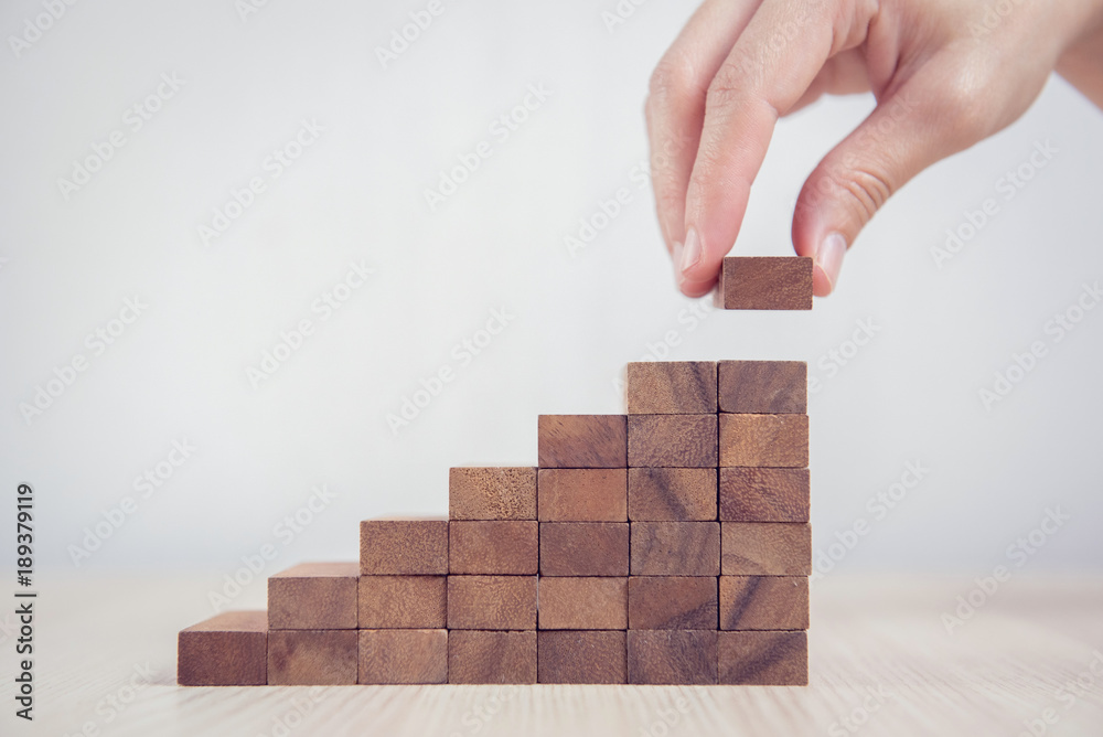 Close up Woman hand arranging wood block stacking as step stair. Business concept growth success process. - obrazy, fototapety, plakaty 