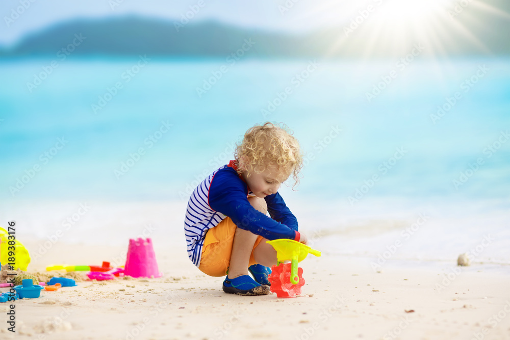 Kids play on tropical beach. Sand and water toy. Kids play on tropical beach. Sand and water toy.