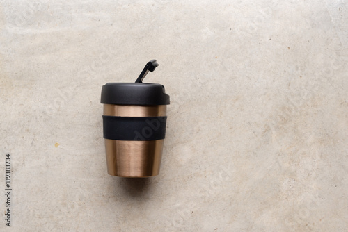 High angle view of reusable coffee cup on concrete background