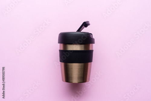 High angle view of reusable coffee cup on pink background