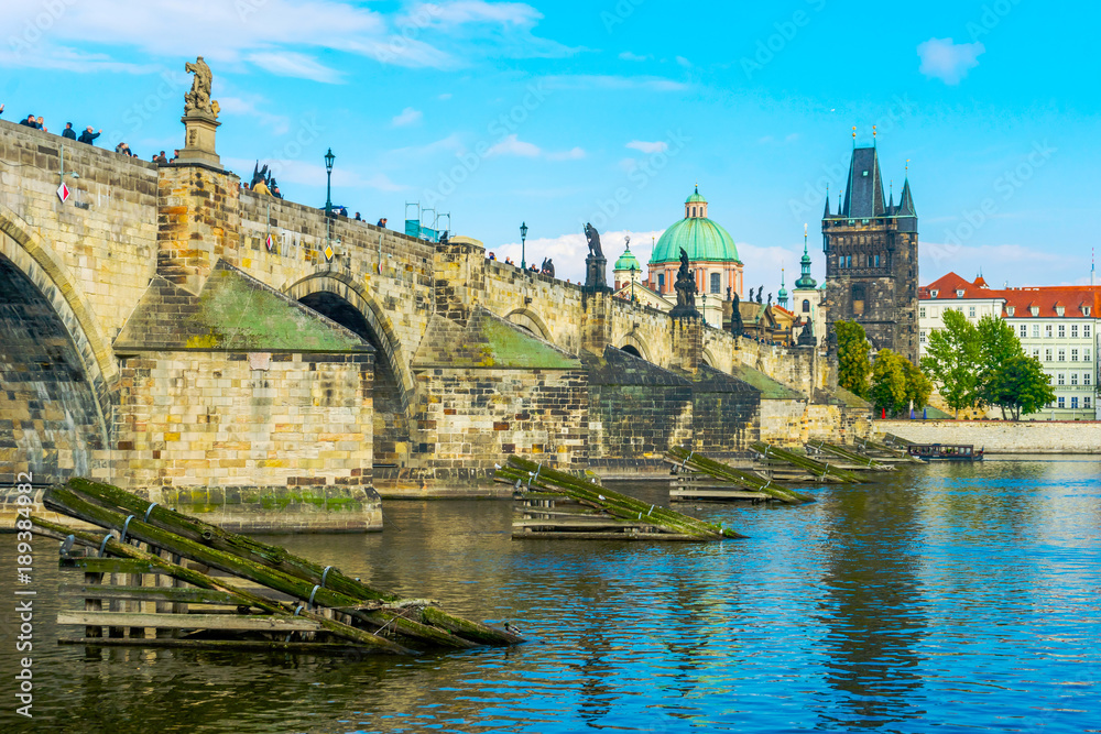 Charles Bridge in Prague in the Czech Republic. Old Town Bridge Tower. The Mill peninsula. Sculptures on the Charles Bridge.  The Vltava River