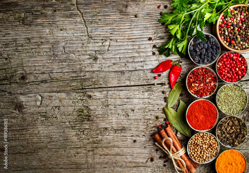 Fototapeta Naklejka Na Ścianę i Meble -  Set of Indian spices on wooden table - Top view
