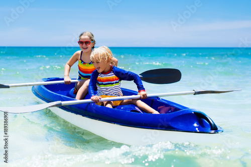 Kids kayaking in ocean. Children in kayak in tropical sea