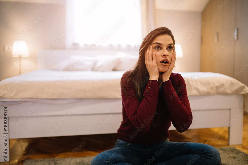 Attractive girl watching TV and feeling surprised. Attractive girl watching TV and feeling surprised.