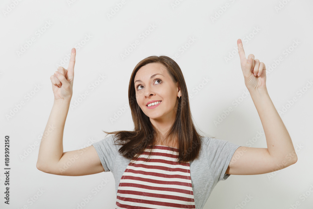 Close up young attractive smiling brunette caucasian housewife in apron isolated on white background. Beautiful housekeeper woman pointing index fingers up looking up. Copy space for advertisement. Close up young attractive smiling brunette caucasian housewife in apron isolated on white background. Beautiful housekeeper woman pointing index fingers up looking up. Copy space for advertisement.