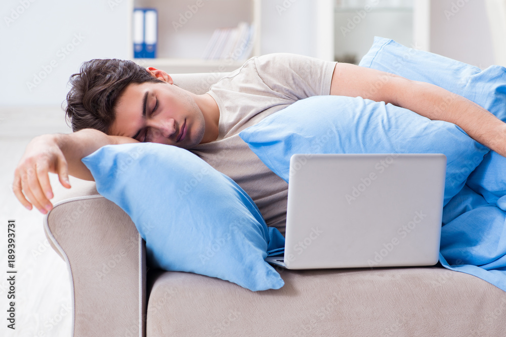 Man working late at his laptop at home Man working late at his laptop at home
