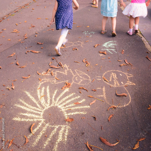 Children walking away from their chalk drawings