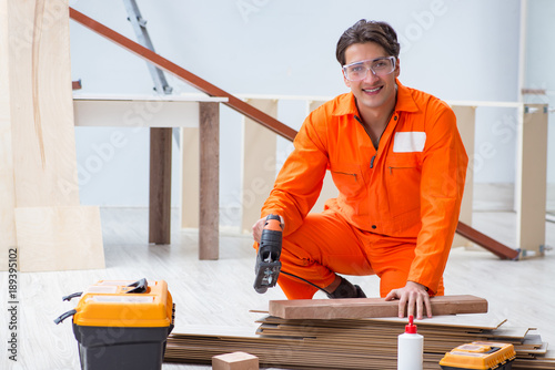 Contractor working on laminate wooden floor