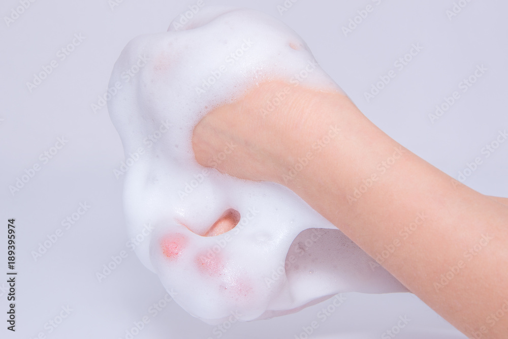 Fototapeta premium Foam of soap or shampoo on female hands