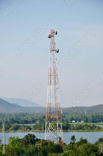 Close up top of communication Tower with antennas such a Mobile phone tower, Cellphone Tower, Phone Pole etc stand on the mountain on white sky background.