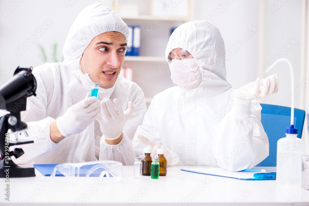 Two chemists working in the lab Two chemists working in the lab