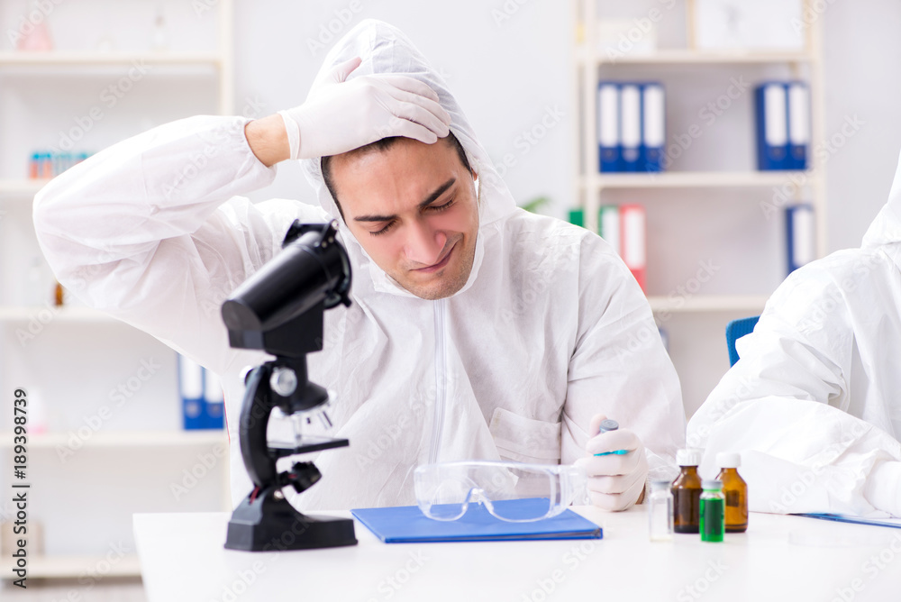Two chemists working in the lab Two chemists working in the lab