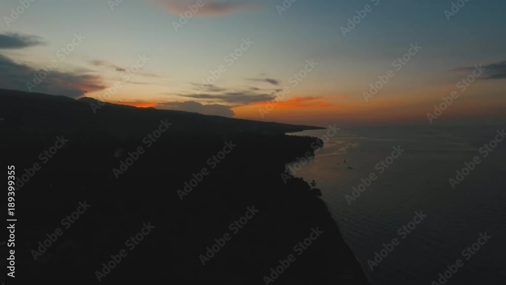 Sea coast at sunset. Aerial view of sunset on the ocean coast, sea, beach, sky, clouds. Bali, Indonesia. Sunset on the island of Bali. 4K, Aerial footage Sea coast at sunset. Aerial view of sunset on the ocean coast, sea, beach, sky, clouds. Bali, Indonesia. Sunset on the island of Bali. 4K, Aerial footage