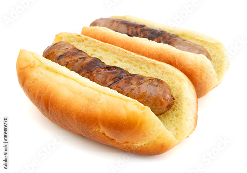 Grilled bratwurst on a bun isolated on white photo