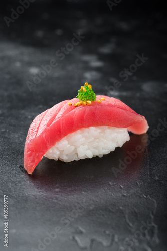 Sushi nigiri with tuna on black background