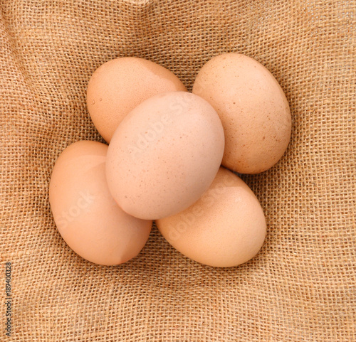 Raw eggs isolated on purlap photo