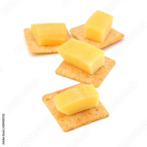 Delicious crackers with cheese on white background