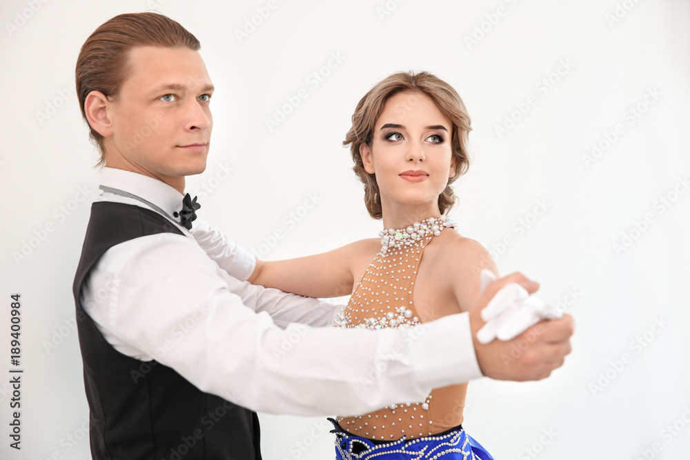 Couple of young dancers on white background