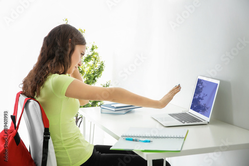 Upset teenage girl with lap...