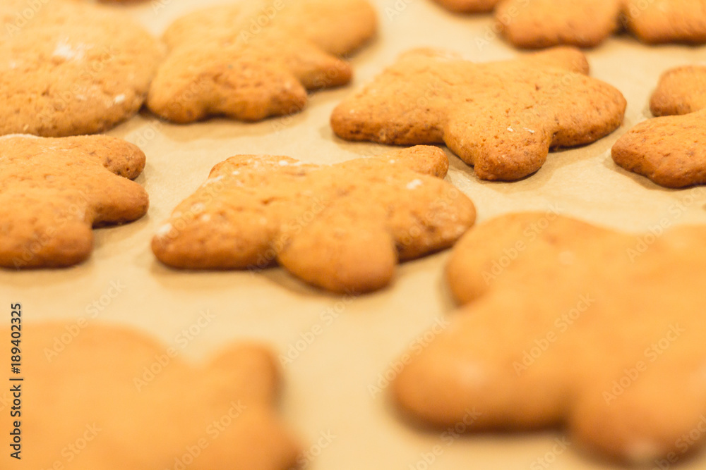 Ginger biscuits lie on a baking sheet. Cookies on baking paper. Selective focus. Ginger biscuits lie on a baking sheet. Cookies on baking paper. Selective focus.