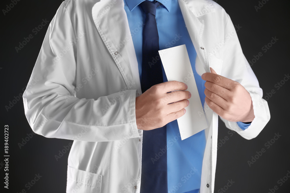 Male doctor putting bribe in pocket on black background Male doctor putting bribe in pocket on black background