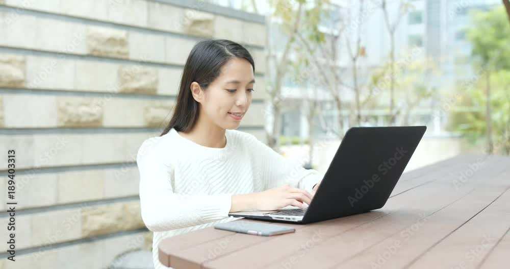 Woman use of notebook computer at outdoor Woman use of notebook computer at outdoor
