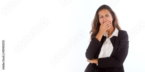 Sleepy and yawning business woman, isolated on a wide background with copy space