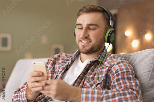 Young man listening to musi...