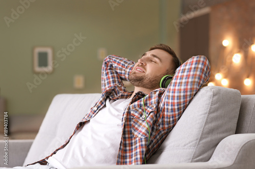 Young man listening to musi...