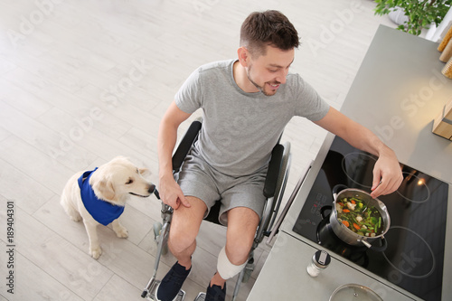 Man in wheelchair cooking w...