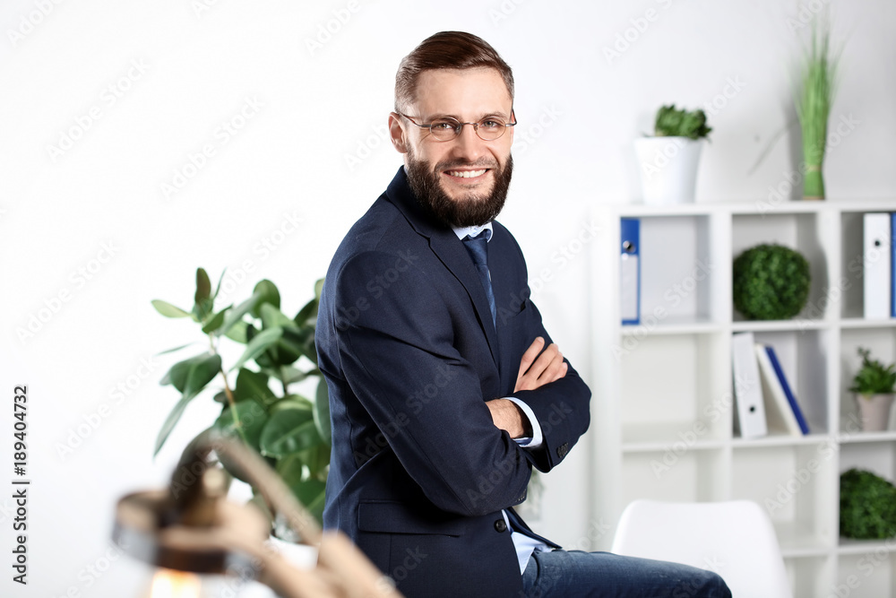 Portrait of handsome businessman indoors