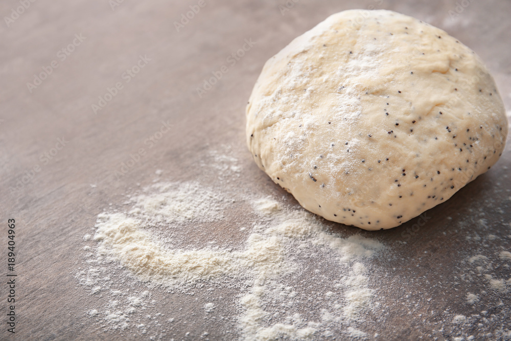 Raw dough with poppy seeds on table Raw dough with poppy seeds on table