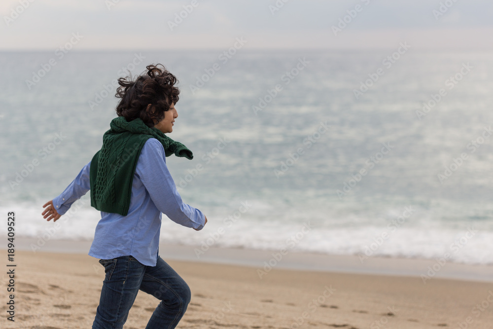 Boy running by the sea
