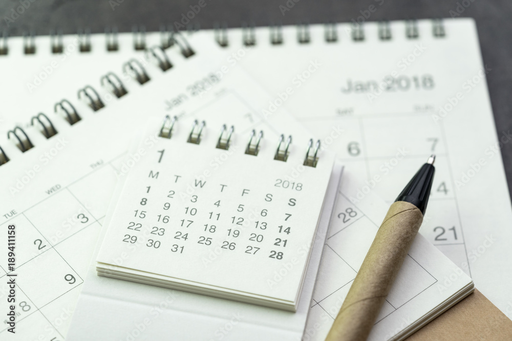 Calendar year plan or appointment reminder concept by pile of white and clean paper calendars with recycled material pen Calendar year plan or appointment reminder concept by pile of white and clean paper calendars with recycled material pen