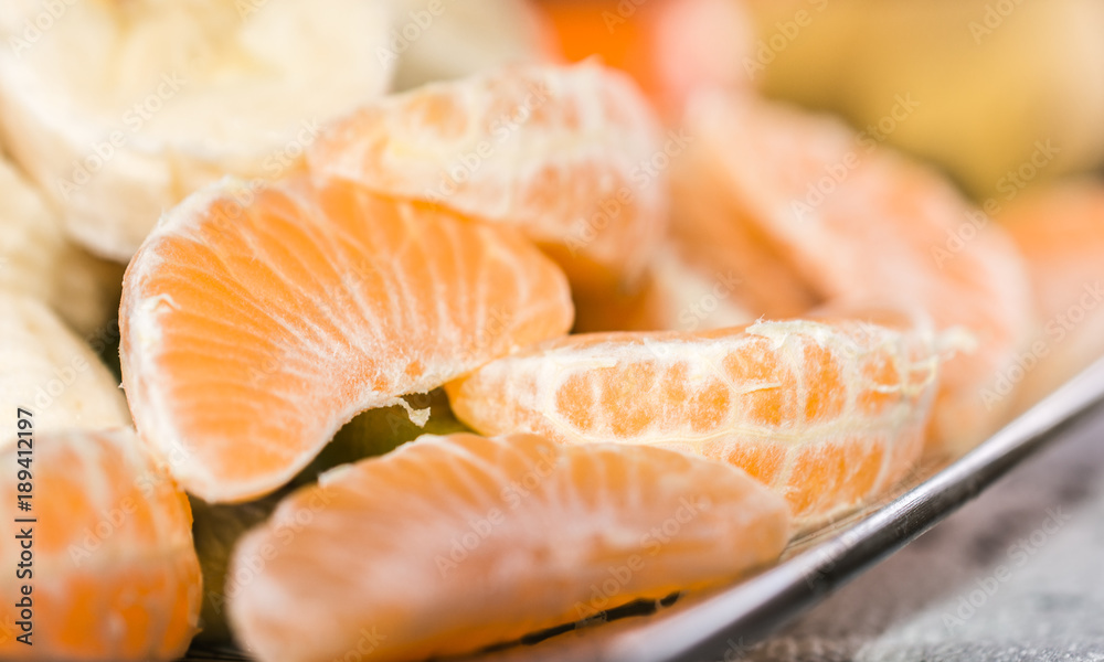 Organic peeled mandarins on a plate.Close up shoot