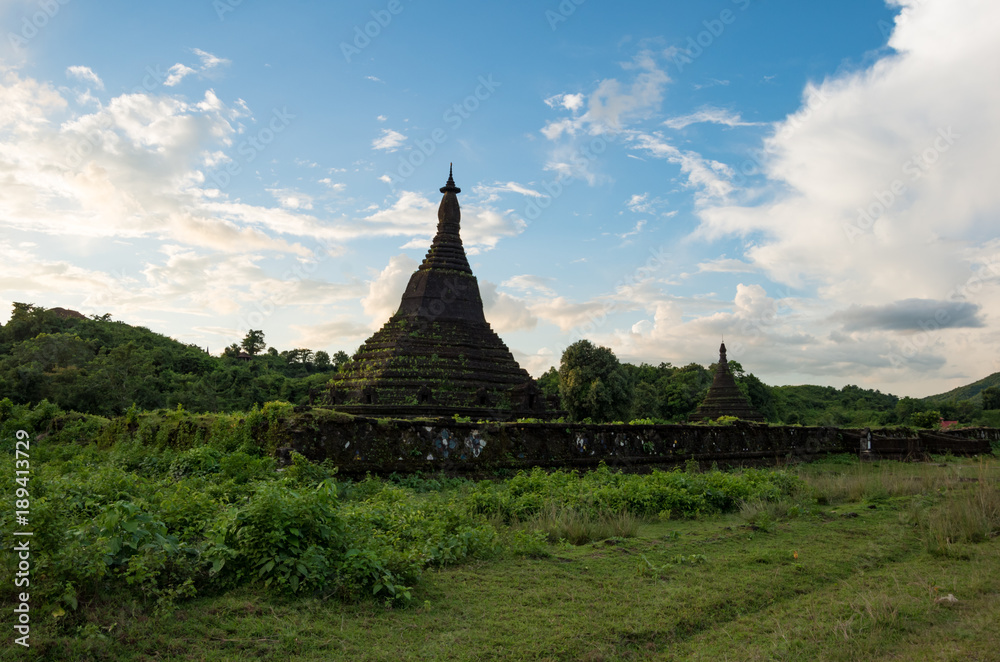 Two ancient pagodas in green landscape and beautiful sky