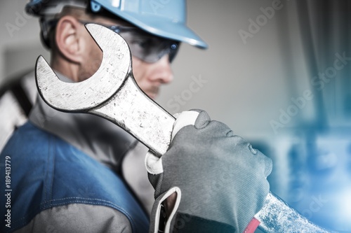 Worker with Huge Wrench photo