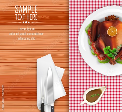 Roasted turkey bird on white plate with fork and knife on wooden table