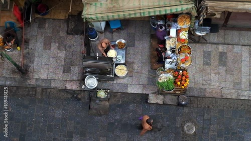 CAIRO, EGYPT - DECEMBER 21, 2017: Aerial view of the outdoor kitchen of small cafe in Al Muizz street, Khan El Khalili Bazaar, cooks make sandwiches in pita with falafel, on December 21 in Cairo. photo
