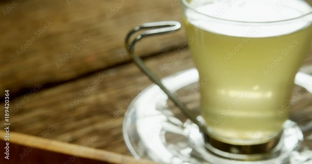 Lemon tea with ginger and lemon on wooden table Lemon tea with ginger and lemon on wooden table