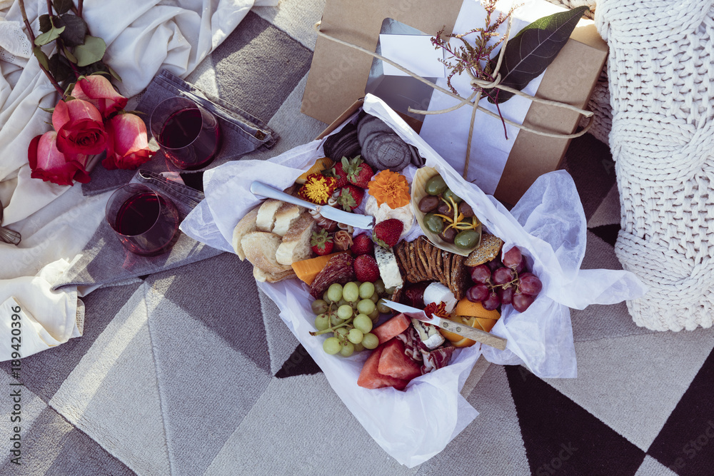 Romantic picnic set up with mixed food platter and wine Stock Photo